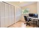 Bedroom featuring hardwood floors, large closets and a built-in desk workspace at 5150 W Colgate Pl, Denver, CO 80236