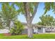 Inviting home featuring mature tree, lush lawn, and charming curb appeal at 5150 W Colgate Pl, Denver, CO 80236