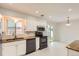 Open kitchen design with a view of the backyard through sliding glass doors at 5150 W Colgate Pl, Denver, CO 80236