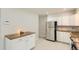 Modern kitchen with stainless steel appliances, white cabinets, granite countertops and light tile flooring at 5150 W Colgate Pl, Denver, CO 80236