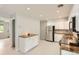 Bright kitchen featuring stainless steel appliances and a view into an adjacent room at 5150 W Colgate Pl, Denver, CO 80236