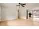 Bright living room featuring hardwood floors, ceiling fan, and open access to the modern kitchen at 5150 W Colgate Pl, Denver, CO 80236
