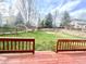 Spacious backyard featuring a well-maintained lawn and a charming red wood deck perfect for relaxation at 6459 S Queen Way, Littleton, CO 80127