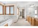 Well-lit bathroom featuring a jacuzzi tub and a double sink vanity with plenty of counter space at 6459 S Queen Way, Littleton, CO 80127