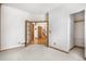 Bright bedroom with closet, carpet flooring and double doors at 6459 S Queen Way, Littleton, CO 80127