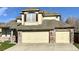 Lovely two-story home featuring a three-car garage and brick and siding exterior at 6459 S Queen Way, Littleton, CO 80127