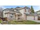 Charming home with a front porch, brick accents, and well-maintained landscaping at 6459 S Queen Way, Littleton, CO 80127