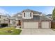 Beautiful home with an attached three-car garage and traditional architectural details at 6459 S Queen Way, Littleton, CO 80127