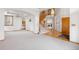 Spacious foyer with new carpet, beautiful wooden staircase, and open floor plan at 6459 S Queen Way, Littleton, CO 80127