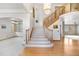 Bright foyer featuring staircase, hardwood floor and elegant chandelier at 6459 S Queen Way, Littleton, CO 80127