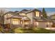 Beautiful two-story home with a brick facade, a well-manicured lawn, and an attached two-car garage at 6459 S Queen Way, Littleton, CO 80127