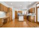 Open kitchen with wood cabinets, stainless steel appliances, and hardwood floors at 6459 S Queen Way, Littleton, CO 80127