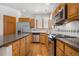 Well-equipped kitchen with stainless steel appliances and beautiful stone countertops at 6459 S Queen Way, Littleton, CO 80127