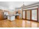 Bright kitchen featuring a center island, stainless steel appliances, and hardwood flooring at 6459 S Queen Way, Littleton, CO 80127