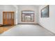 Bright living room with a large window, neutral carpeting, and decorative wood trim at 6459 S Queen Way, Littleton, CO 80127