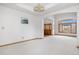 Well-lit living room featuring new carpet, a picture window, and an arched entryway at 6459 S Queen Way, Littleton, CO 80127