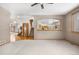 Spacious living room filled with natural light connects to the dining and kitchen area at 6459 S Queen Way, Littleton, CO 80127