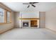 Cozy living room featuring a fireplace, a window and neutral carpet at 6459 S Queen Way, Littleton, CO 80127