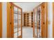 Office with glass french doors and built-in wooden bookshelves at 6459 S Queen Way, Littleton, CO 80127