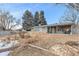 Spacious backyard with brick home and large trees at 8094 E Kenyon Pl, Denver, CO 80237