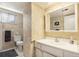 Functional bathroom with tiled walls, a white vanity sink, and essential fixtures for daily use at 8094 E Kenyon Pl, Denver, CO 80237