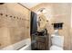 Well-appointed bathroom featuring modern fixtures, a vanity sink, and a shower/tub combination at 8094 E Kenyon Pl, Denver, CO 80237