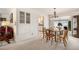 Bright dining room features built-in storage and an adjacent kitchen for Gathering meals and entertaining guests at 8094 E Kenyon Pl, Denver, CO 80237