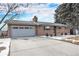 Charming single-story brick home with a two-car garage and a well-maintained front yard with winter landscaping at 8094 E Kenyon Pl, Denver, CO 80237