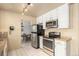 Well-equipped kitchen featuring stainless steel appliances, granite countertops, white cabinets, and eat-in dining at 8094 E Kenyon Pl, Denver, CO 80237