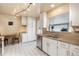 Bright kitchen featuring stainless steel appliances, granite countertops, white cabinets, and a view to the patio at 8094 E Kenyon Pl, Denver, CO 80237