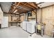 Unfinished basement laundry room with shelving and utility sink at 8094 E Kenyon Pl, Denver, CO 80237