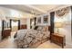 Serene bedroom features a ceiling fan, large bed, warm lighting, and window coverings for a cozy and inviting ambiance at 8094 E Kenyon Pl, Denver, CO 80237