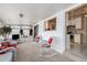 Bright sunroom with white wicker furniture, view to kitchen at 8094 E Kenyon Pl, Denver, CO 80237