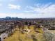 Scenic aerial view showcases a neighborhood near a park with a city skyline at 4344 Wyandot St, Denver, CO 80211