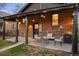 Covered back patio with brick and wooden features, complete with cozy seating arrangements at 4344 Wyandot St, Denver, CO 80211