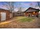 Wide backyard featuring a brick house, a shed and a patch of green grass at 4344 Wyandot St, Denver, CO 80211