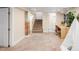 Finished basement area with exposed brick, carpeted floor, and stairs leading to an upper level at 4344 Wyandot St, Denver, CO 80211