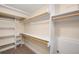 Walk-in closet with wooden hanging rods and storage shelves at 4344 Wyandot St, Denver, CO 80211