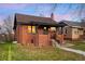 Quaint brick home with neat landscaping and inviting front porch at dusk at 4344 Wyandot St, Denver, CO 80211