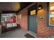 Welcoming front porch with a bench, brick wall, and a stylish gray front door at 4344 Wyandot St, Denver, CO 80211