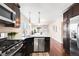 Modern kitchen featuring stainless steel appliances and dark wood cabinetry at 4344 Wyandot St, Denver, CO 80211