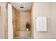 Elegant walk-in shower featuring tiled walls, shower seat, and rainfall shower head at 4344 Wyandot St, Denver, CO 80211