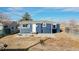 Cozy backyard featuring a fire pit, ample space, and a small patio area by the home's entrance at 3282 W 66Th Ave, Denver, CO 80221
