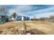 Cozy backyard featuring a fire pit, ample space, and a small patio area by the home's entrance at 3282 W 66Th Ave, Denver, CO 80221