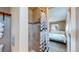 Bathroom featuring a tiled shower and view into the bedroom at 3282 W 66Th Ave, Denver, CO 80221
