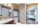 Bathroom with modern fixtures and finishes, with view into the bedroom at 3282 W 66Th Ave, Denver, CO 80221