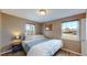 Comfortable bedroom with hardwood floors, abundant natural light, and soothing neutral color palette at 3282 W 66Th Ave, Denver, CO 80221