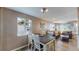 Cozy dining area with modern lighting, natural light, and hardwood floors open to the living room at 3282 W 66Th Ave, Denver, CO 80221