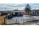 Charming exterior view of a single-story home with a white picket fence and a bright blue door at 3282 W 66Th Ave, Denver, CO 80221