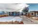 Quaint blue house with a snow-covered yard and driveway at 3282 W 66Th Ave, Denver, CO 80221